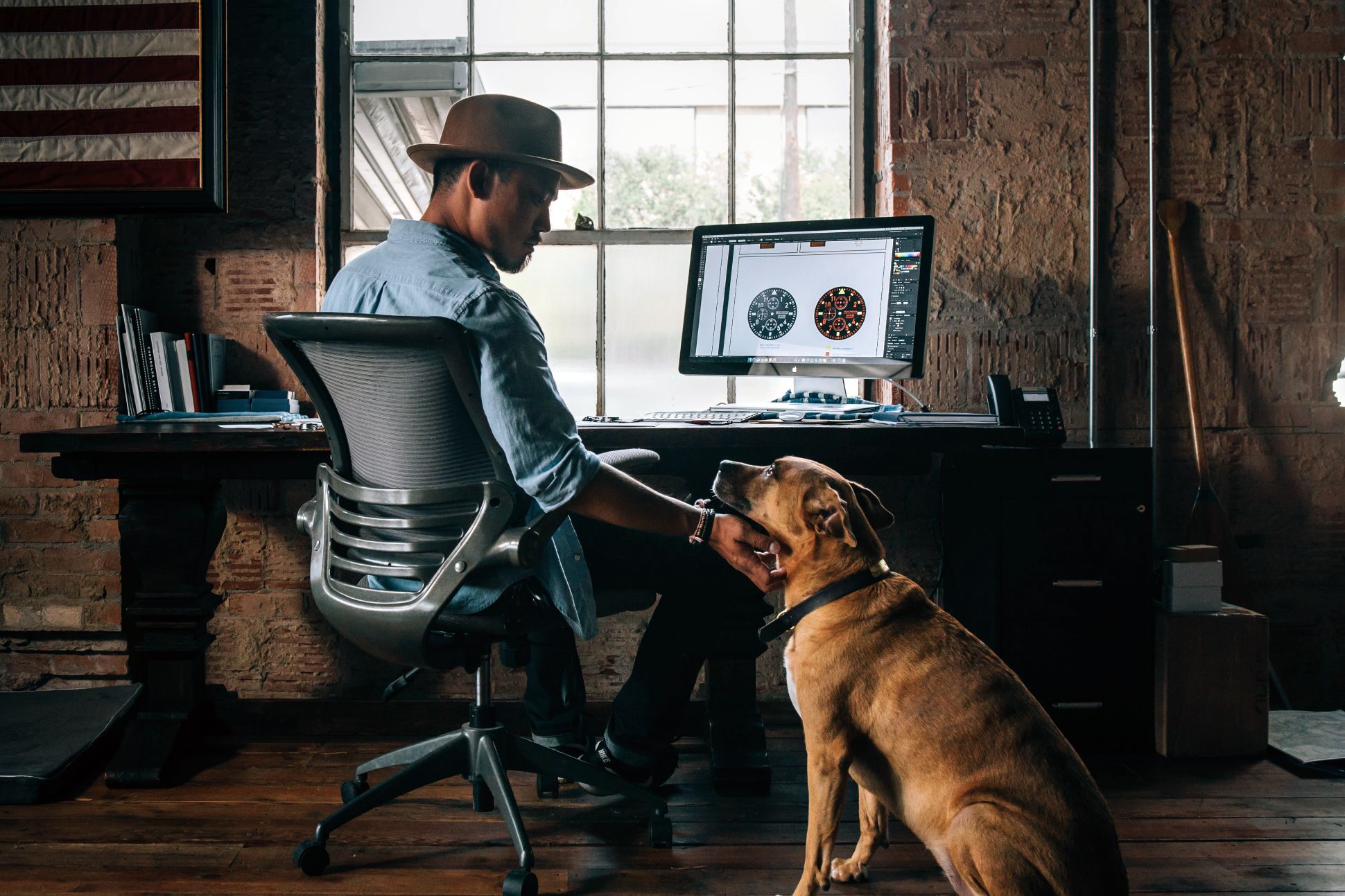 Man with dog in home office; bamboo chair mats