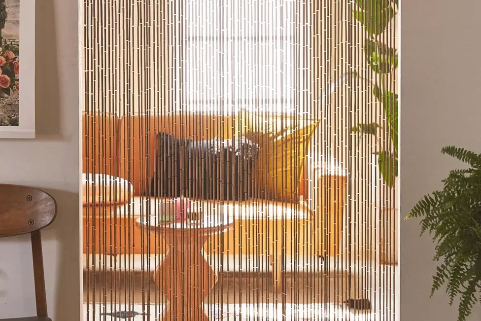 Bamboo beaded curtain in a home's doorway, separating rooms