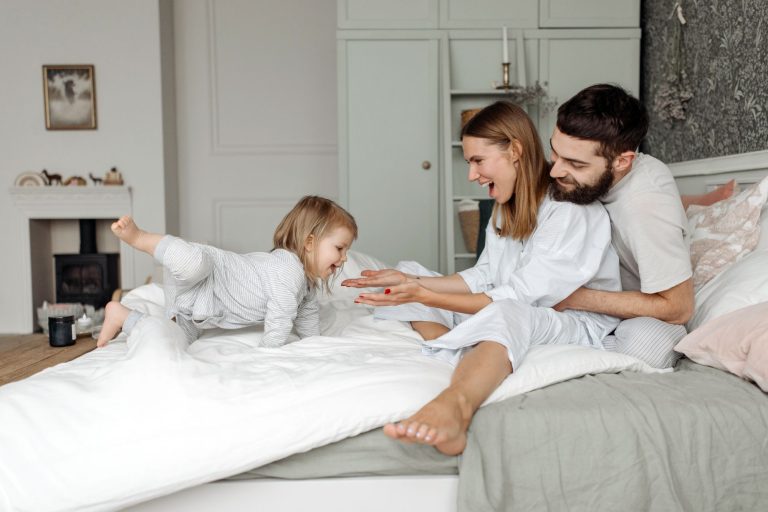 Family on bed wearing bamboo pajamas